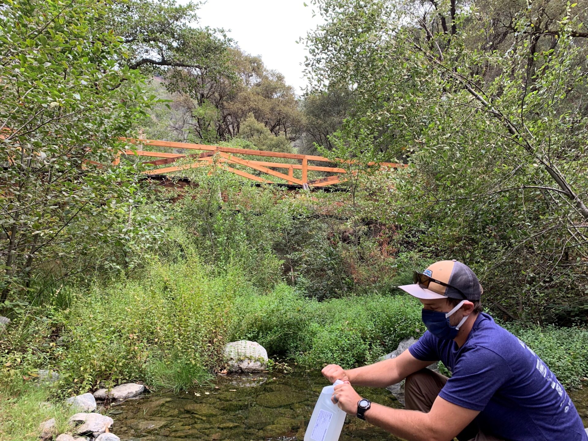 SYRCL Hydrologist, Karl Ronning, conducting River Monitoring at Rush Creek with a mask on
